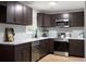 A modern kitchen is showcased with dark wood cabinets, stainless steel appliances, and white countertops at 2442 Falcon Ct, Lawrenceville, GA 30043