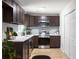 Updated kitchen offers stainless steel appliances, dark wood cabinets, and a stylish backsplash at 2442 Falcon Ct, Lawrenceville, GA 30043