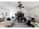 Bright living room with large windows, modern furniture, and a cozy fireplace at 2442 Falcon Ct, Lawrenceville, GA 30043