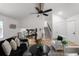 Bright living room with high ceilings, ceiling fan, stairs, and an open view into the kitchen at 2442 Falcon Ct, Lawrenceville, GA 30043