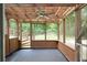 An empty screened-in porch featuring a ceiling fan and wooden deck with wooded views at 2442 Falcon Ct, Lawrenceville, GA 30043
