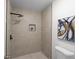 Modern shower with neutral-toned tile, black hardware and showerhead, and a small alcove with a plant at 2442 Falcon Ct, Lawrenceville, GA 30043