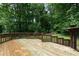 Large wooden deck features multiple levels and views of mature trees in a private backyard at 2442 Falcon Ct, Lawrenceville, GA 30043