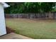 Spacious backyard with a wood fence offering privacy and a secure area for outdoor activities at 282 Ellesmere Court, Buford, GA 30518