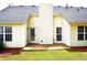 Backyard patio area with a door to the house and view of the landscaped yard at 282 Ellesmere Court, Buford, GA 30518