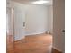 A bright bedroom with hardwood floors and a white door offers a clean and modern look at 282 Ellesmere Court, Buford, GA 30518