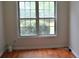 Bedroom with hardwood floors and a window overlooking the backyard at 282 Ellesmere Court, Buford, GA 30518