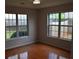 Bright bedroom with hardwood floors, and large window at 282 Ellesmere Court, Buford, GA 30518