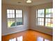 Bedroom with hardwood floors, with natural light from two large windows overlooking the backyard at 282 Ellesmere Court, Buford, GA 30518