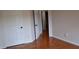 Cozy bedroom featuring hardwood floors, a white door and neutral wall color to accommodate any decor at 282 Ellesmere Court, Buford, GA 30518