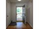 Inviting entryway with hardwood flooring and a view of the landscaped front yard through the storm door at 282 Ellesmere Court, Buford, GA 30518