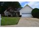 Charming single-Gathering home featuring a well-maintained lawn and a two-car garage at 282 Ellesmere Court, Buford, GA 30518