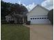 Charming single-story home featuring a well-manicured lawn, two-car garage, and classic suburban appeal at 282 Ellesmere Court, Buford, GA 30518