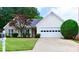 Charming home with a well-maintained lawn, mature landscaping, and a two-car garage at 282 Ellesmere Court, Buford, GA 30518