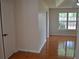 Hallway view with hardwood floors, a door on the left and a window at the end at 282 Ellesmere Court, Buford, GA 30518