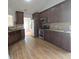 Eat-in kitchen featuring granite countertops, stainless steel appliances and dark wood cabinetry at 282 Ellesmere Court, Buford, GA 30518