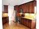 Well-appointed kitchen featuring warm wood cabinets, stainless steel appliances, and granite countertops at 282 Ellesmere Court, Buford, GA 30518
