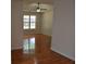 Living area featuring hardwood floors, a ceiling fan, and a large window at 282 Ellesmere Court, Buford, GA 30518