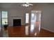 Open-concept living space with fireplace, hardwood floors, and a view of the adjacent room at 282 Ellesmere Court, Buford, GA 30518