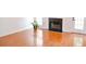 Bright living room features shiny hard wood floors, fireplace and large windows at 282 Ellesmere Court, Buford, GA 30518