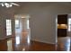 View of the dining space and kitchen from the living room with hardwood floors and neutral walls at 282 Ellesmere Court, Buford, GA 30518