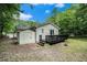 Charming home's backyard with a dark deck and shed in a lush, leafy setting, creating a serene outdoor space at 376 Pine Ne St, Marietta, GA 30060