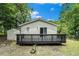 Backyard featuring a dark deck, shed, and lush greenery offers a private outdoor retreat for relaxation and entertainment at 376 Pine Ne St, Marietta, GA 30060