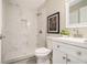 This bathroom includes stylish tiled shower, a modern white vanity with sink, toilet, and updated fixtures at 376 Pine Ne St, Marietta, GA 30060