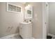 This bathroom has a modern white vanity with sink, mirror, and updated fixtures at 376 Pine Ne St, Marietta, GA 30060