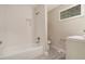 This bathroom includes tiled shower and tub combo, a modern white vanity with sink, toilet, and updated fixtures at 376 Pine Ne St, Marietta, GA 30060