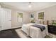 The bedroom features dark floors, a patterned rug, and a large bed with neutral and blue accents at 376 Pine Ne St, Marietta, GA 30060