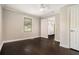 This bedroom has dark wood floors and white trim with one window and a ceiling fan at 376 Pine Ne St, Marietta, GA 30060