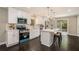Bright kitchen features modern white cabinets, stainless steel appliances, island with bar seating, and sliding door at 376 Pine Ne St, Marietta, GA 30060