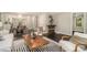 Open-concept living space with hardwood floors, modern furniture, and a seamless flow to the dining area at 376 Pine Ne St, Marietta, GA 30060