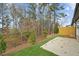 A cozy backyard featuring a concrete patio, new fence and mature trees offering privacy at 8210 Sonata Ln, Cumming, GA 30041
