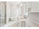 Modern bathroom with a glass-enclosed shower, soaking tub, dual sinks and quartz countertops at 8210 Sonata Ln, Cumming, GA 30041