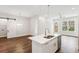 Stylish kitchen island with a sink, stainless steel appliances and an open layout concept at 8210 Sonata Ln, Cumming, GA 30041