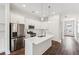 Modern kitchen featuring stainless steel appliances and a large island with pendant lighting at 8210 Sonata Ln, Cumming, GA 30041