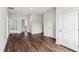 Open-concept living area featuring hardwood floors, ample natural light, and access to other rooms at 8210 Sonata Ln, Cumming, GA 30041