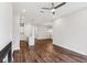 Bright open concept area with fireplace, modern ceiling fan and hardwood flooring at 8210 Sonata Ln, Cumming, GA 30041