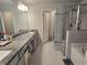 Bathroom featuring double sinks, granite counters, tiled floor, a glass enclosed shower, and soaking tub at 2264 Shetley Creek Dr, Norcross, GA 30071