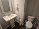 Cozy bathroom features a pedestal sink and white toilet at 2264 Shetley Creek Dr, Norcross, GA 30071