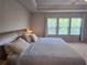 Spacious bedroom featuring a tray ceiling and an abundance of natural light from a bank of windows at 2264 Shetley Creek Dr, Norcross, GA 30071