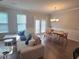 A dining room with modern furniture and natural light coming from a large window at 2264 Shetley Creek Dr, Norcross, GA 30071