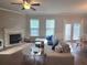 Spacious living room featuring a fireplace, large windows, and comfortable seating at 2264 Shetley Creek Dr, Norcross, GA 30071