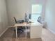 Spacious home office features a white desk and large window for natural light at 2264 Shetley Creek Dr, Norcross, GA 30071