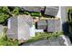 Aerial view of townhomes with neatly arranged rooftops, surrounded by lush greenery and well-maintained landscapes at 6715 Pond Rd, Cumming, GA 30040