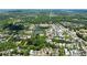 Expansive aerial view of a residential community with lush greenery, tranquil lakes, and community amenities at 6715 Pond Rd, Cumming, GA 30040