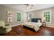 Bedroom featuring hardwood floors, neutral colored walls, many windows, and comfortable seating at 6715 Pond Rd, Cumming, GA 30040