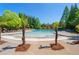 Resort-style community pool surrounded by lush greenery, palm trees, and comfortable lounge chairs for ultimate relaxation at 6715 Pond Rd, Cumming, GA 30040